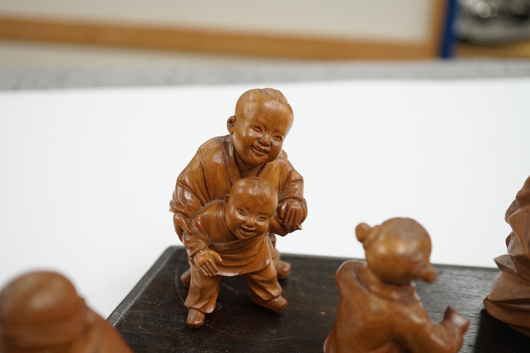 A set five Chinese carved boxwood figures of children playing Blind man’s Buff, Republic period, 23cm wide. Condition - good